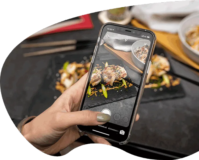 woman taking a photo of her food to post on social media