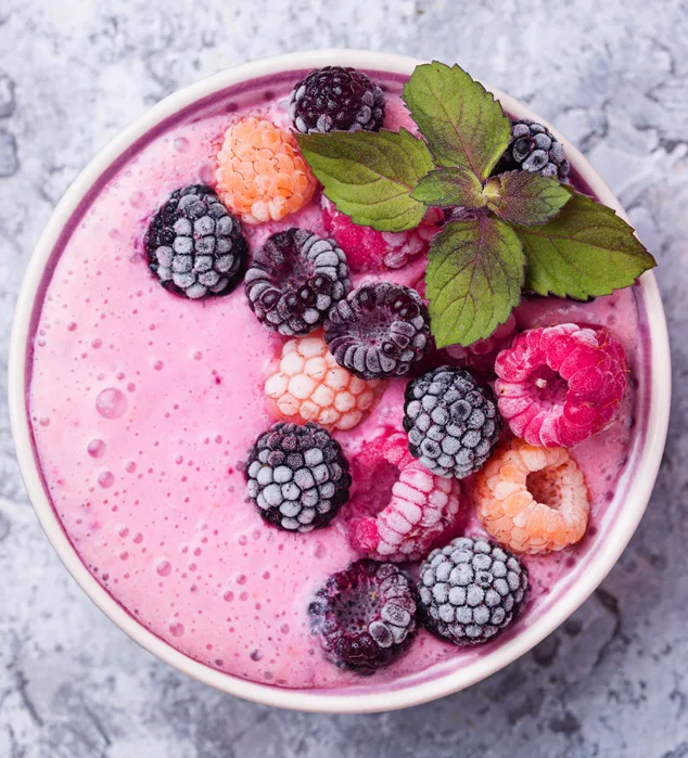 pink yogurt and fruit in bowl